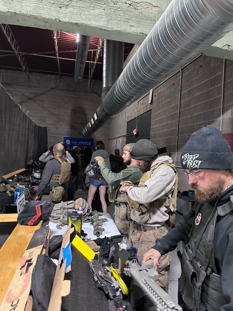 Tactical players checking gear at the staging table before a match at ATR