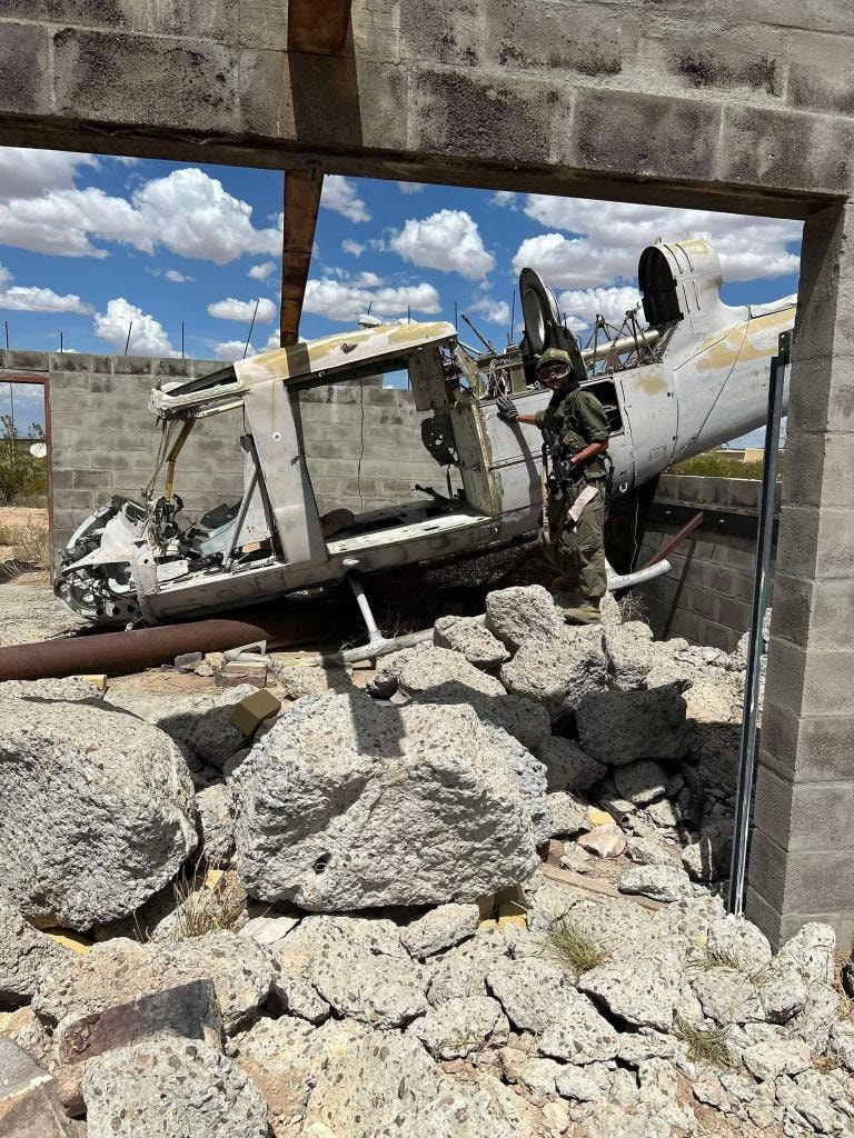 Player standing next to a downed helicopter prop at American Milsim Copperhead XI