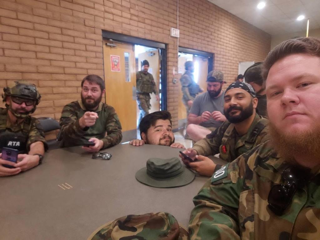 ATR team members gathered around a table at the American Milsim Copperhead XI briefing