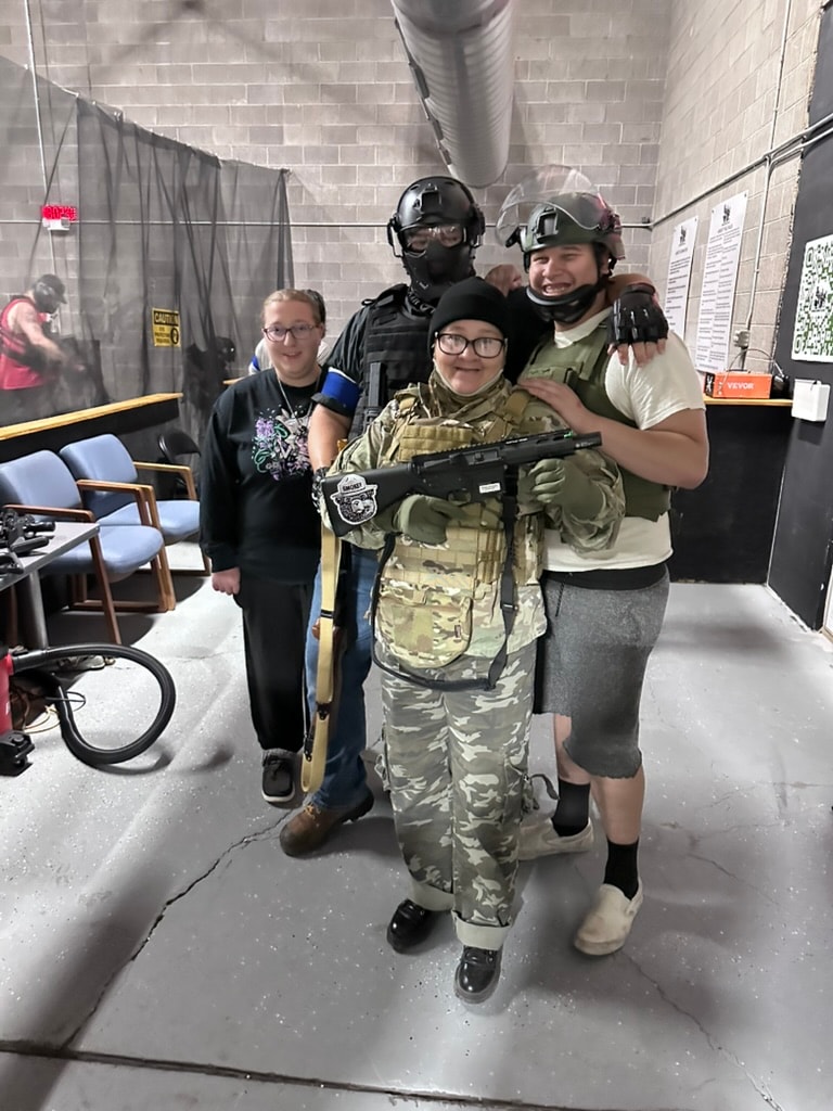Group of players in tactical gear laughing together in the staging area at ATR