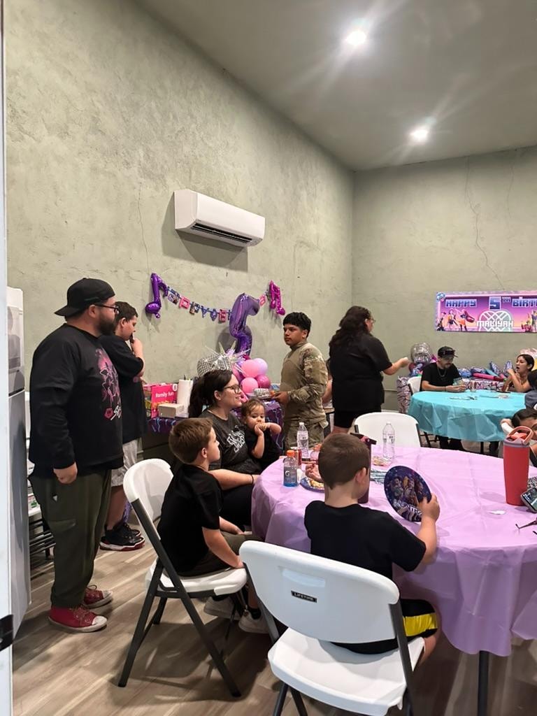 Party guests gathered around decorated tables at Malia's 5th birthday celebration at ATR