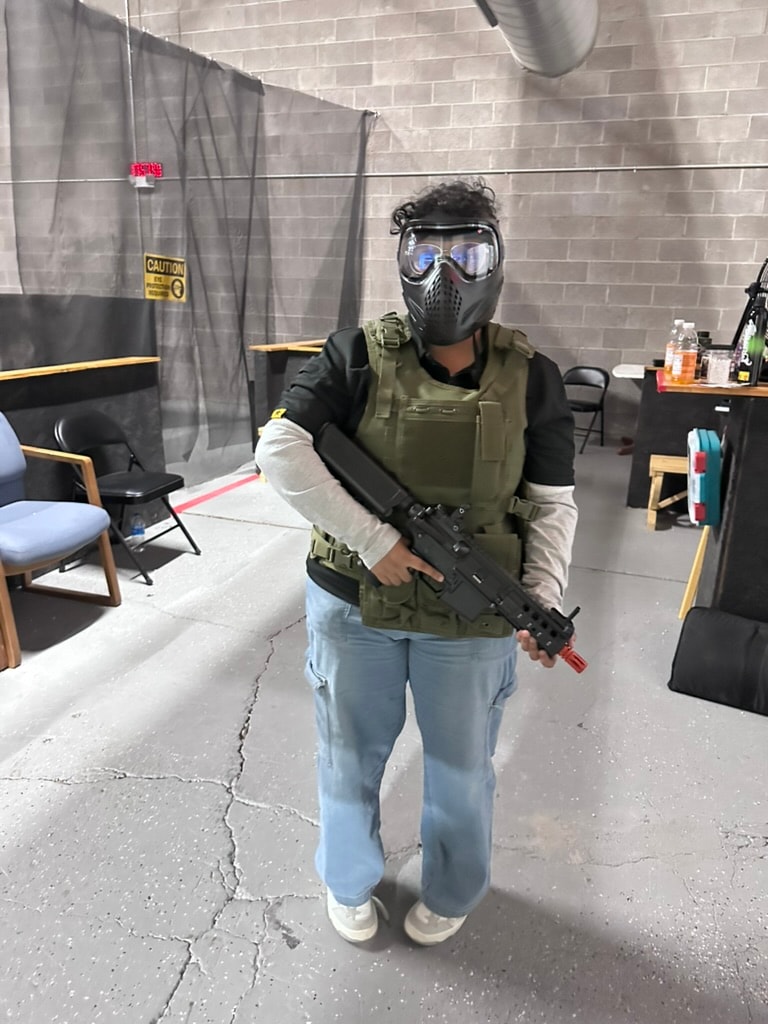 Player in full tactical gear and mask holding an airsoft rifle at ATR